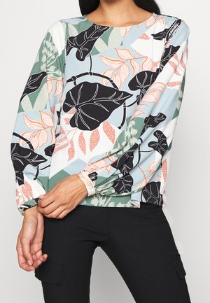Camicia a maniche lunghe con motivo floreale in azzurro chiaro, caratterizzata da foglie nere e fiori pesco. Tessuto morbido con una vestibilità rilassata e maniche arricciate.