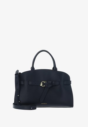 Sac à main en cuir bleu marine avec poignées supérieures, bandoulière ajustable, boucle dorée et petit logo "Coccinelle" sur le devant.
