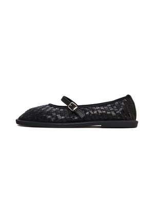 Black woven leather flat shoes with an adjustable strap and a rounded toe, featuring a smooth texture and a minimalistic design.