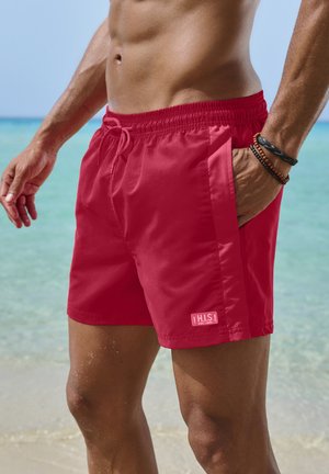 Rote Badeshorts aus leichtem Material, mit einem elastischen Bund und Kordelzug, Seitentaschen und einem kleinen Logotag.