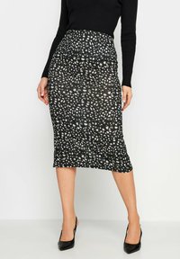 Mustat kynähame, joka esittelee teksturoidun designin epäsäännöllisillä valkoisilla ja harmailla pilkuilla. Korkea vyötärö, puolipitkä ja joustava kangas.