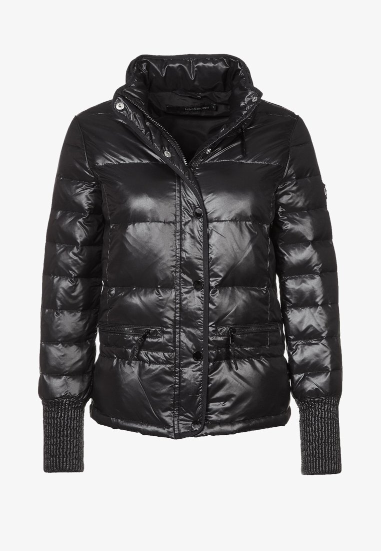 Black puffer jacket made of shiny, quilted material. Features a high collar, snap buttons, zippered pockets, and textured knit cuffs.