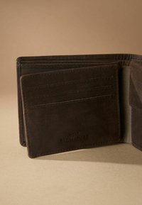 Brown leather wallet with multiple card slots, a note compartment, and a textured interior. Features embossed branding and stitched edges.