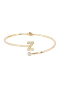 Gold-tone bangle bracelet featuring a "Z" shaped design with rhinestone accents and a clear stone detail. Sleek, minimalist construction.