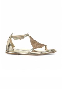Sandalo metallico dorato con un accento bronzeo testurizzato. Presenta una fascia alla caviglia regolabile, design open toe e suola piatta.