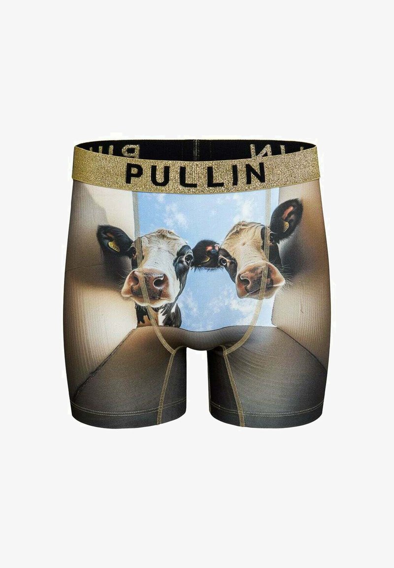 Boxer imprimé motif vache noir et blanc avec une ceinture élastique dorée portant l'inscription "PULLIN." Le tissu semble lisse et extensible.