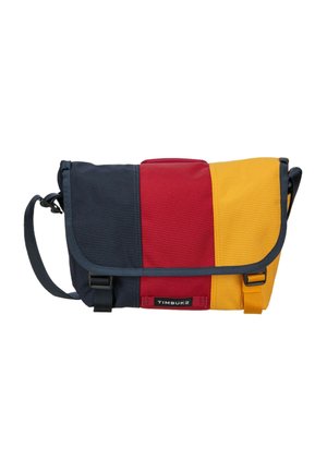 Messenger bag with blue, red, and yellow vertical stripes, adjustable shoulder strap, front buckle closures, and Timbuk2 logo on flap.