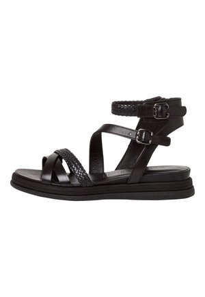 Mustat nahkasandaalit, joissa on punottuja hihnasomisteita, säädettävä nilkkahihna ja litteä kumipohja. Ominaisuutena tyylikäs, minimalistinen muotoilu.