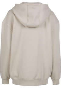 Beige hettegenser med avslappet passform, mykt stoff, ribbede ermavslutninger og hem. Usynlig søm og et enkelt, u dekorert design.
