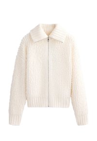 Biela textúrovaná bunda so zipsom, s rebrovaným golierom a manžetami. Materiál má jemný, chlpatý vzhľad s pohodlným dizajnom.