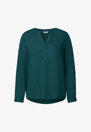 Blouse verte à manches longues en matière lisse. Dotée d'un décolleté en V, d'une patte de boutonnage et de manches à poignet avec un ourlet arrondi.