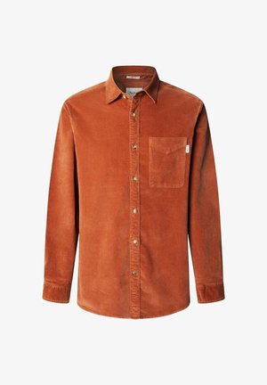 Chemise en velours côtelé orange avec des manches longues, une poche poitrine unique et un col arrondi. Présente des coutures visibles et des boutons métalliques.