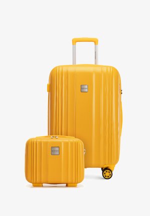 Two bright yellow textured suitcases, one large with telescopic handle and wheels, one smaller with top handle, both branded "Wittchen."