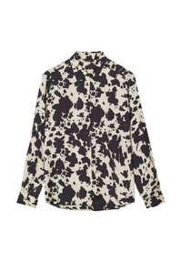 Camicia button-up a maniche lunghe di colore crema con motivo a macchie di mucca nere, dotata di colletto e taglio dritto con dettagli a bottoni sul davanti.