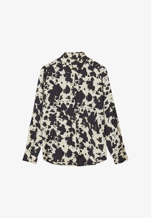 Camicia button-up a maniche lunghe di colore crema con motivo a macchie di mucca nere, dotata di colletto e taglio dritto con dettagli a bottoni sul davanti.