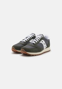 Green and gray athletic shoes with white laces, mesh and suede material, and a brown rubber sole. Features a distinct white logo on the side.