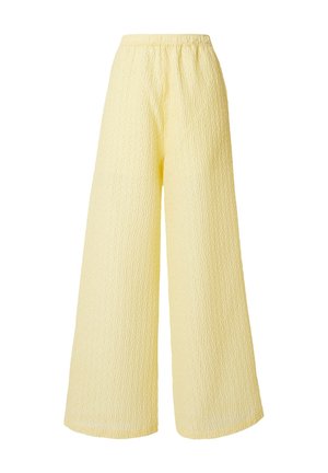 Wide-leg pants in pale yellow with elastic waistband and subtle textured pattern on fabric.