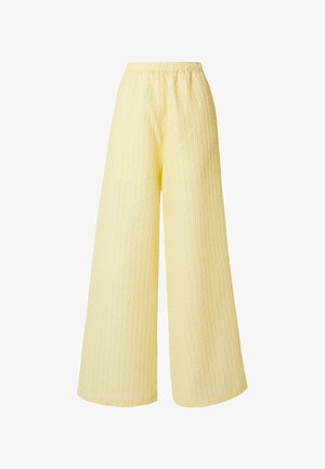 Wide-leg pants in pale yellow with elastic waistband and subtle textured pattern on fabric.