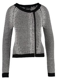 Cardigan tricoté pour femmes noir et blanc avec manches longues, encolure ronde et fermeture éclair à l'avant.