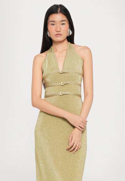 Gold halter-neck dress made of shimmering fabric, featuring three gold circular accents at the waist and a fitted silhouette.