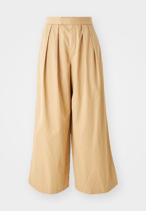 Beige, magas derekú, bő szárú nadrág, elöl pliszírozott és sima, texturált pamut anyagból készült.