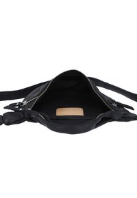 Black leather handbag with a soft texture, zippered closure, and an interior pocket featuring a beige label tag. Adjustable shoulder strap.