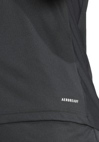 Black athletic fabric with a smooth texture, featuring a white "AEROREADY" logo near the hem and a streamlined design.