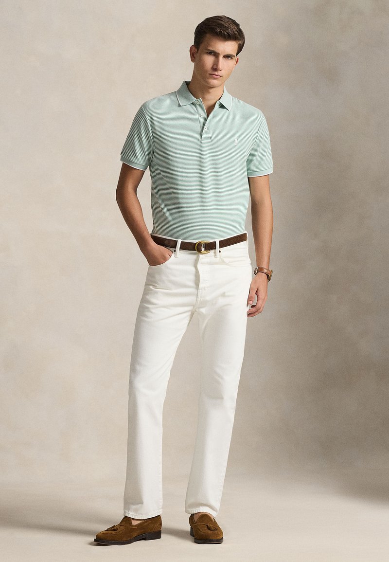 Light green striped polo shirt, white straight-leg trousers, brown leather belt, and brown suede loafers. Smooth texture, classic fit.