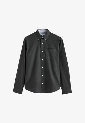 Zwarte langwerpige button-up shirt van katoen, met een button-down kraag, één borstzak en witte knopen. De textuur lijkt glad.