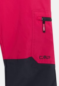 Κόκκινες και μαύρες αδιάβροχες παντελόνες με φερμουάρ και λογότυπο CMP. Διαθέτουν σχεδίαση με χρώματα σε μπλοκ και απαλή, ελαφριά υφή υφάσματος.