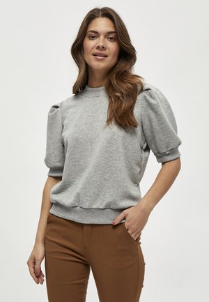 Gray sweatshirt with puff sleeves, ribbed neckline, and hem. Soft texture, casual fit, paired with brown pants. Simple design, minimal detailing.