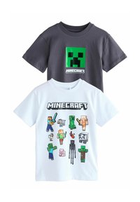 Deux t-shirts à manches courtes. Un gris avec un graphisme de Creeper Minecraft vert ; l'autre blanc présentant divers personnages pixélisés de Minecraft.