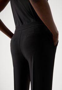 MARCIANO BY GUESS ELLA CHAIN STRAIGHT PANTS - Kalhoty - black