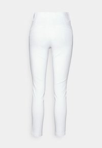 White trousers with a slim fit, flat waistband, and cropped length. Features two back pockets and a smooth, non-textured fabric.