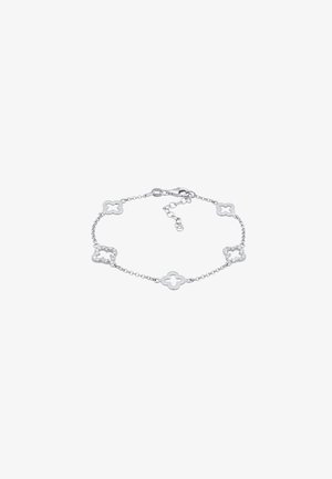 Sølv kædearmbånd med seks kløverformede led, der skiftes imellem enkle og cubic zirconia-belagte designs, med en lås i lobster stil.