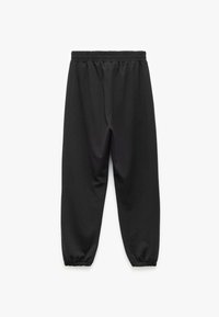 Schwarze Jogginghose aus weichem Stoff, mit einem elastischen Bund, schmalen Beinen und elastischen Bündchen an den Knöcheln.