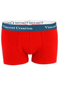 Boxer-culottes en coton rouge avec une ceinture élastique bleue. La ceinture présente le texte "Vincent Creation" en blanc. Texture lisse.