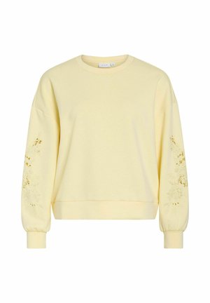 Hele valgelt pikkade varrukatega dressipluus lilleliste lõikega varrukatel, soonikkoes mansettidega ja ümmarguse kaelusega.