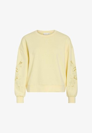 Hele valgelt pikkade varrukatega dressipluus lilleliste lõikega varrukatel, soonikkoes mansettidega ja ümmarguse kaelusega.