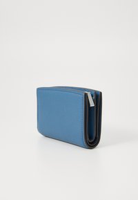 Portafoglio in pelle blu con una texture liscia, angoli arrotondati e chiusura a zip; presenta un rivestimento interno nero a contrasto.