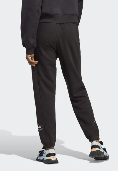 Schwarze Sweatpants mit elastischen Bündchen, die ein Logodetail am linken Bein aufweisen. Hergestellt aus einem weichen Baumwollmix mit entspannter Passform.