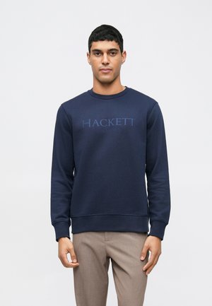 Marineblå sweatshirt med rund hals og lange ærmer, prydet med et forhøjet, tonal logo "HACKETT LONDON" på brystet. Blød tekstur.