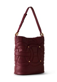 Burgundy leather shoulder bag with adjustable strap, embossed circular pattern, and gold-tone rivet details on front.