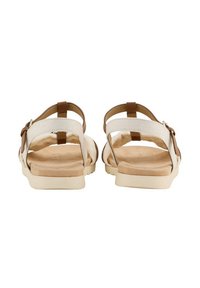 Braune und cremefarbene Sandalen mit verstellbaren Riemen, einer gepolsterten Innensohle und einer flachen Gummisohle. Das Design verfügt über eine offene Ferse hinten.