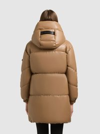 Long, puffy brown jacket with a high collar, elastic cuffs, and a matte finish. Features a black logo detail on the back of the hood.