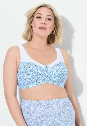 Blauwe bloemenprint beha met witte bandjes en rand, met een strikaccent in het midden. De stof heeft een zachte textuur en een gladde afwerking.