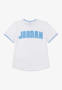 White mesh jersey with light blue accents, featuring "JORDAN" in large blue letters on the back and contrasting trim around the neckline.