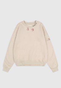 Felpa color crema con scollo rotondo, spalle cadute e vestibilità rilassata. Presenta grafiche rosa: "39" e "SINCE" sul colletto.