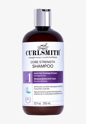 Brun, rund flaske med en sølvhætte. Etiketten har sort og lilla tekst. 12 fl oz. Indeholder ingredienser som kaktusfigner og grønkålsblade.