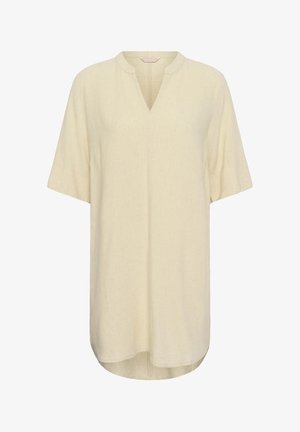 Ohlapna bež kratka tunika s kratkimi rokavi z V-izrezom in zaobljenim ovratnikom, izdelana iz lahkotne tkanine, z rahlo ukrivljenim robom.